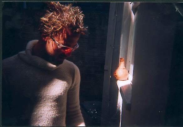 Espen Kjendlie in warm lamplight beside a candle-lit window